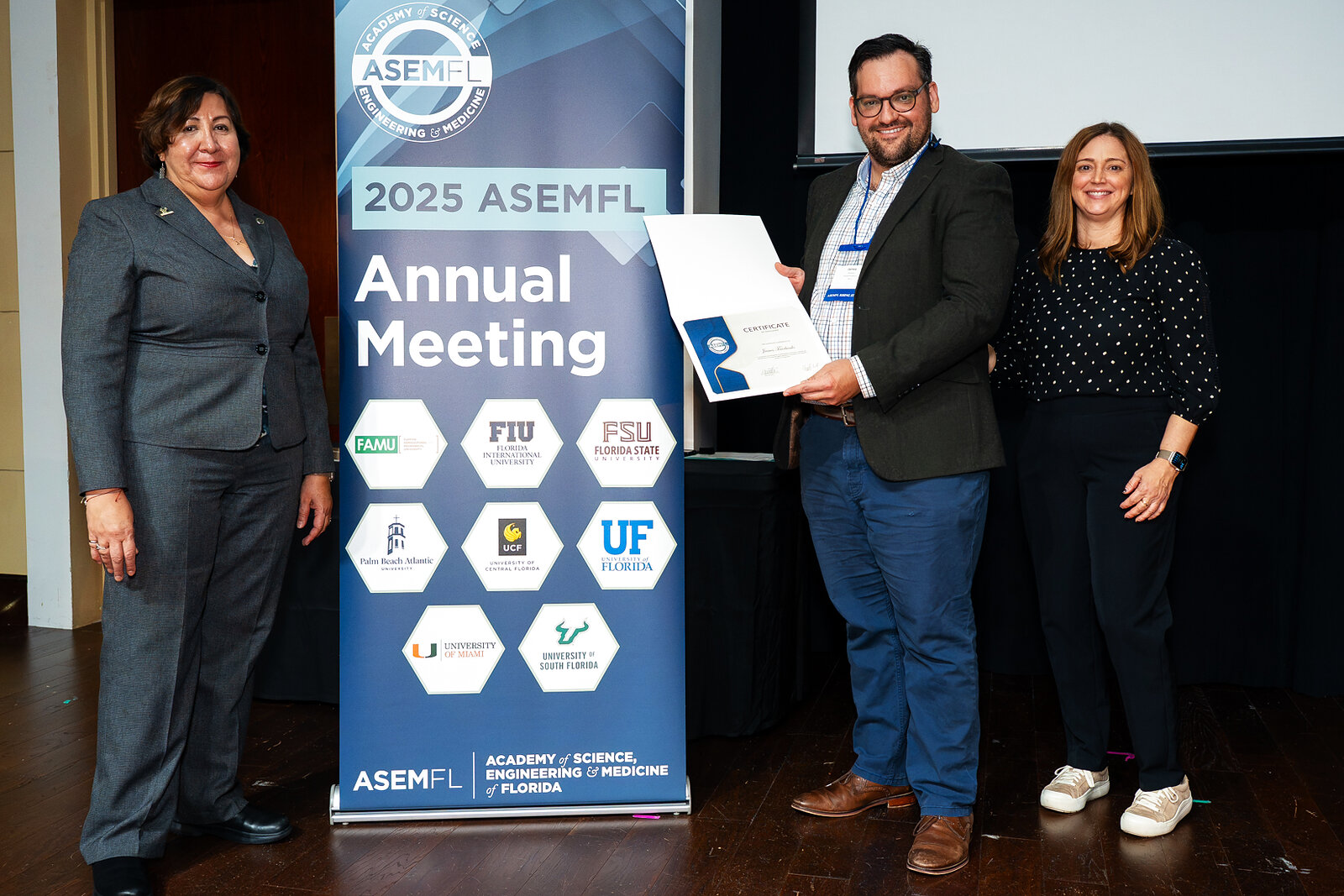 James Fairbanks receiving the ASEMFL Rising Star award at the 2025 Annual Meeting